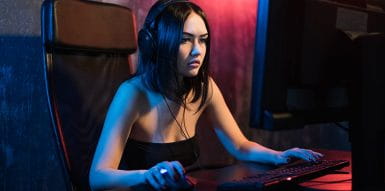 Image of a young woman in front of computer with Streamer profile