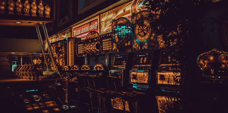 Image of the Interior of a casino illuminated by Slot Machines